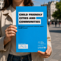 lady holding unicef child friendly city report